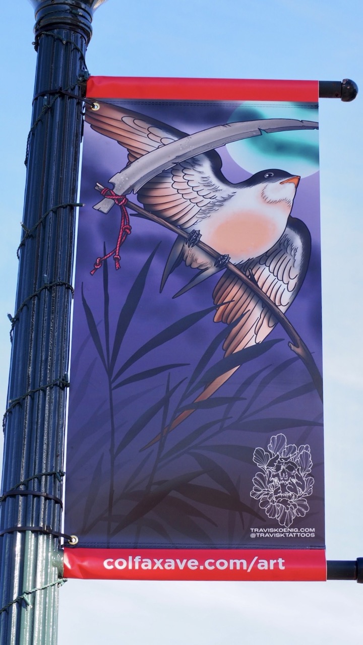 Photo of a tattoo designed street banner on Colfax Ave.
