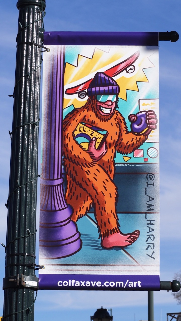 Photo of a tattoo designed street banner on Colfax Ave.