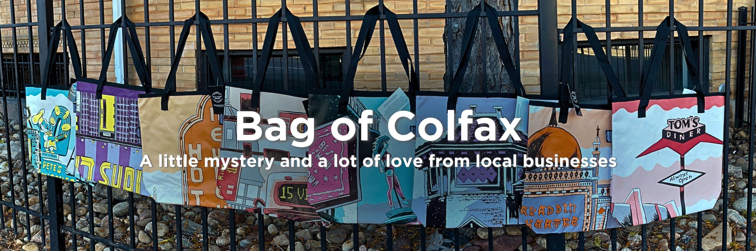 eight tote bags hanging from a fence